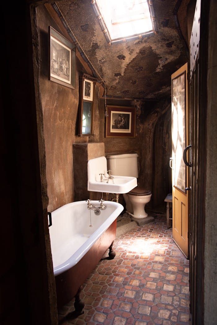 services-06 Explore this charming vintage bathroom featuring an antique clawfoot tub and rustic interior design.